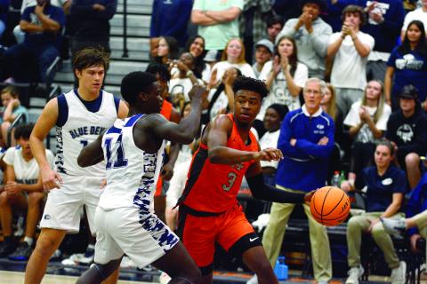 Tahj Johnson fights off Elbert defenders in the last home basketball game on Dec. 3. 