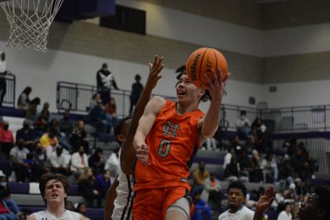 Johnny Curry fights through traffic to get the layup against Monroe Area on Friday, Jan. 7.