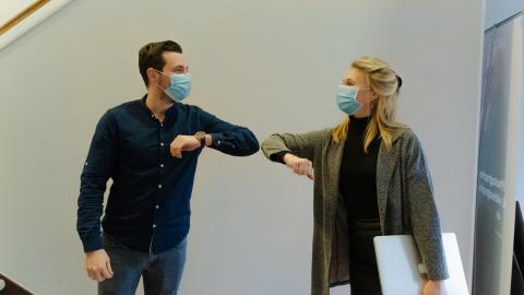 Man and woman practice COVID protocols. Photo credit: Maxime