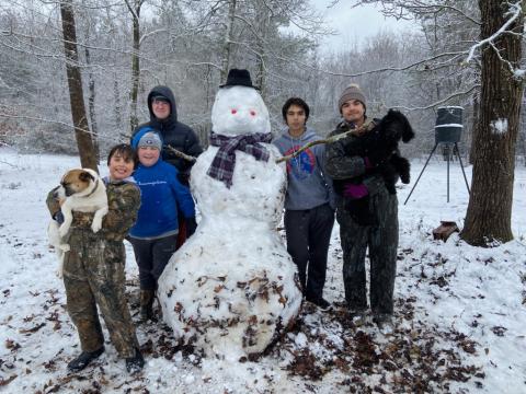 Kids in Hartwell enjoy a rare opportunity to get outside and build a snowman. Pictured from left to right, Tate Oglesby with dog Rocky, Brady Vickery, Blake Vickery, Tucker Oglesby and Payne Oglesby with dog Izzy.  
