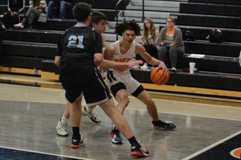 Johnny Curry fights through Daniel defenders along the baseline in the Dog’s loss on Wednesday, Dec. 29.