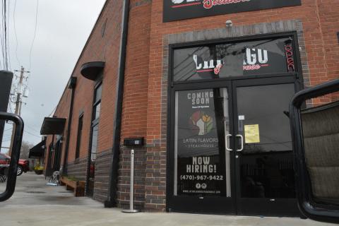 A sign indicating that Latin Flavors will be “coming soon” currently on the door at  33 Carolina Street. 
