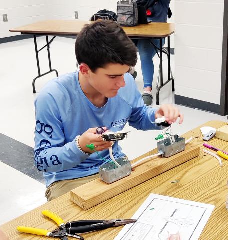 Photo submitted Hart County Middle School student Boston Graham wires an outlet circuit during an ag mechanics unit. 