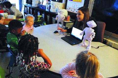 Kindergarten teacher, Mrs. Hannah Jones, sets up ABii to read aloud to a group of students. 