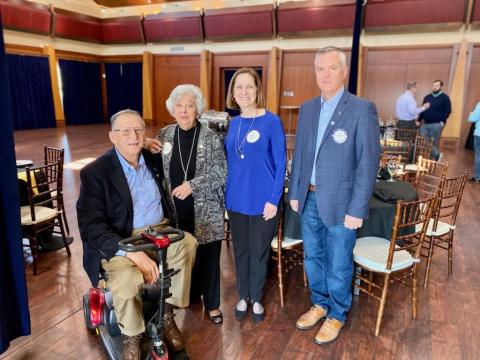 From left to right, Rotarian Joe Whittemore, Barbara Edmunds, Cathy Edmunds Redfern and Rotary president Rich Mewborn smile after celebrating a moment for their friend and family member Jack Edmunds. 