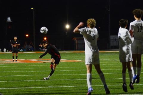Luis Genchi tries to curve a penalty shot around the Prince Avenue wall.