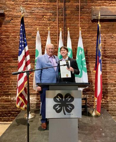 Senator Lee Anderson presenting Ben Tellano with the Senate proclamation.