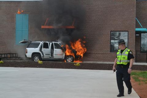 A car at the drive-thru window of Popeyes Chicken in Hartwell engulfed in flames Tuesday. The car, occupied by a family of five was picking up food when their vehicle caught fire. No one was harmed and the cause of the fire is unknown. 