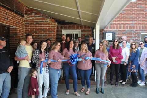 Megan McCurley joins a large Hartwell contingency and cuts the ribbon on the new Doula at Hart office at 236 W. Franklin Street. 