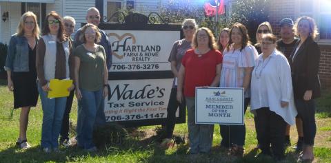 Pictured left, realtors and other Hartland employees join Chamber reps in front of the Hartland Realty office.