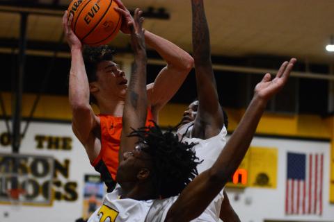 Johnny Curry takes a shot in traffic in his final high school game at Thomson High School on Saturday, Feb. 25.