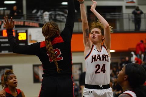 Abbygail McLane shoots over one of her opponents.
