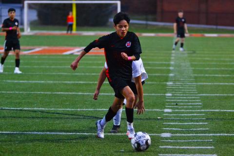 Luis Genchi takes on several defenders before scoring a goal against Crescent.