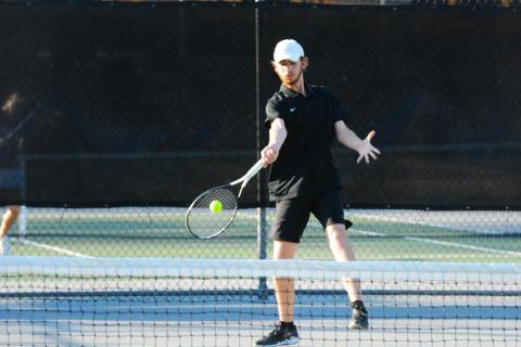Daniel Leard returns serve against East Jackson on March 3.