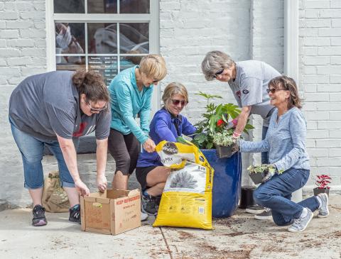 Main Street volunteers (L-R) Amanda Brown, Karen Vahaly, Chrissy Warren, Sandra Baker and Carol Beazley freshen up Depot Street.