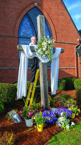 Bruce Herring puts the finishing touches on the cross at Hart First United Methodist Church.