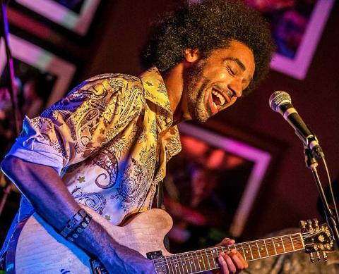 Selwyn Birchwood playing guitar during a set. 