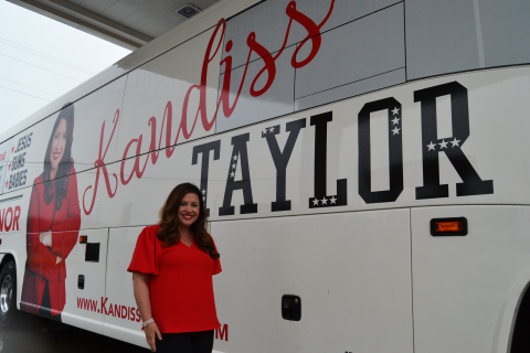 Gubernatorial candidate Kandiss Taylor stands outside her campaign bus at Hartwell Ingles. 