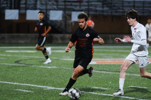 Senior Aidan Gordon pushes the ball down field in his last home game as a Bulldog.