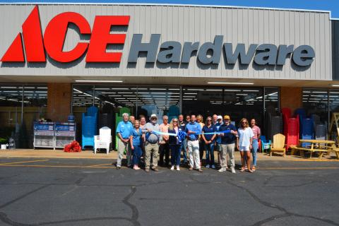 Community members meet for a ribbon cutting at Ace. 