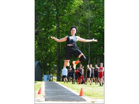 Johnny Curry flies through the air during the long jump at a home meet in Hart County earlier this season. Curry qualified for state championships in long jump, high jump and triple jump.