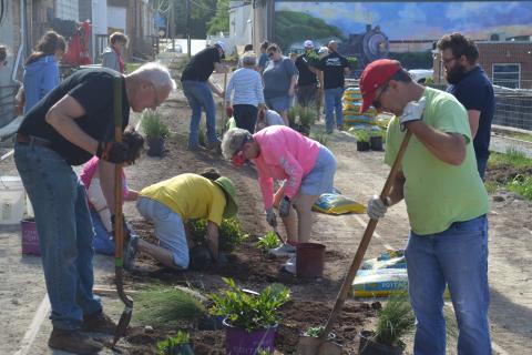Volunteers help plant at the Railroad Street Park last week. 
