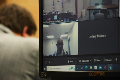 Norwood, seen above, attending his hearing virtually.