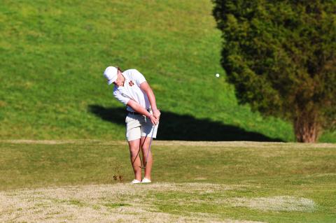 Kip Phillips takes a chip shot in a match against Oconee County earlier this season.