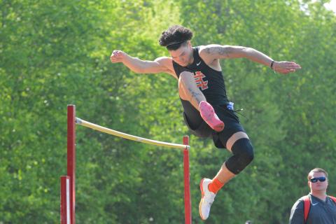 Johnny Curry clears a high jump attempt at the home meet on April 21.
