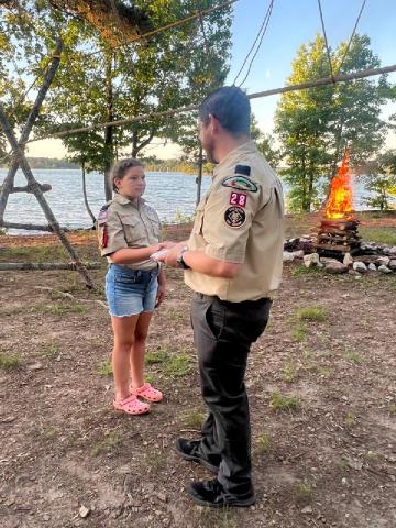 Evie McCurley, with her dad Josh McCurley, at the Scouts’ graduation ceremony. 