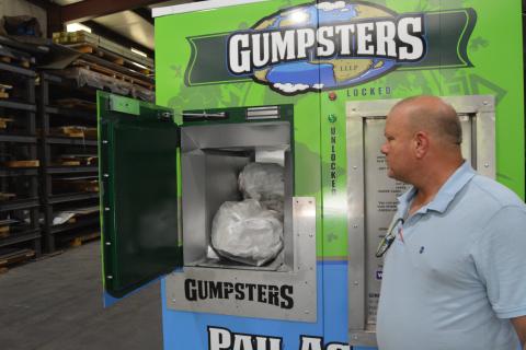 Pictured above, Gumpsters creator Kim Herron displays how his “pay as you throw” receptacle is used. Herron is hoping to set up Gumpsters, seen left, in Hart County and expects other Georgia Counties to follow suit.  