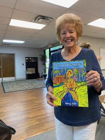 Kay Cleveland shows off her coloring book, which serves as a map of historical places in Hartwell. 