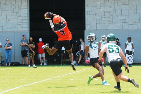 Jashon Gaines snags a pass over the head of Collins Hill defenders.