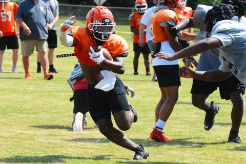 Running back Nori Moore makes a cut away from a Morgan County defender