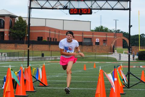 Zachery Benner stumbles past the finish line to finish first overall in the Historic Hartwell 5K on June 2. 