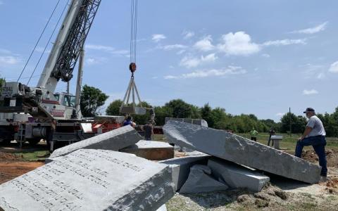 An agent from the Georgia Bureau of Investigation surveys the scene at the Georgia Guidestones early Wednesday morning after an explosion damaged the monument, leaving one of the slabs in a pile of rubble. (Photo by Rose Scoggins)