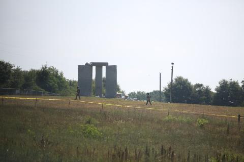 Members of the Georgia Bureau of Investigation bomb disposal unit scan the scene at the Georgia Guide Stones, one of which apparently exploded Wednesday morning.
