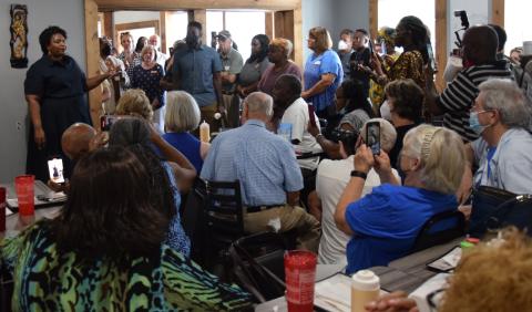 Democratic candidate Stacey Abrams (left) brought her campaign for governor to Royston Thursday, speaking to an overflow crowd at Little Japan Restaurant. 