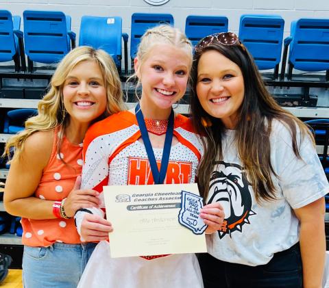 Ally Anderson (center) with her coaches Mollie Payne (left) and Ashley Risner (right) at the competition in Columbus on Saturday, Aug. 6.