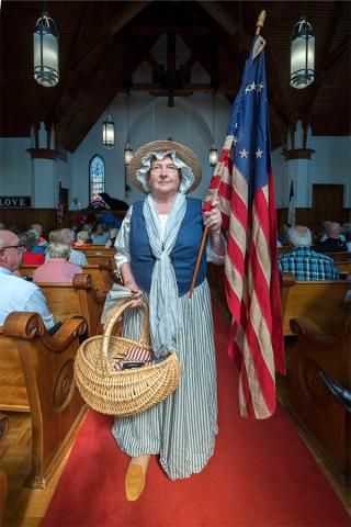 Sara Lesseur dons her Nancy Hart attire at the annual 4th of July service at Hartwell First United Methodist Church last month. 