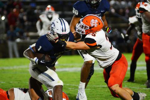 Cyrus Bowen wraps up the Elbert County running back in the backfield on Aug. 19. 