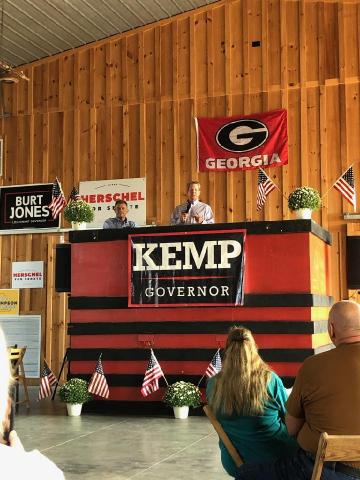 Governor Brian Kemp, alongside state House Rep. Alan Powell, speaks to an audience at Britt Angus Farm in Hartwell on Saturday, Sept. 17. Kemp was one of 10 notable Republican speakers in a “Meet the candidates” event.