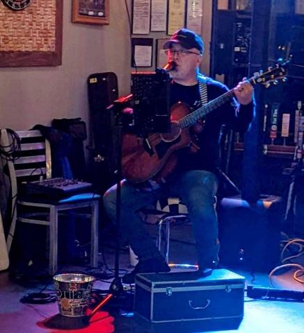 Hart County EMS worker David Pruitt entertains a crowd at Fender’s Alley in Cornelia. 