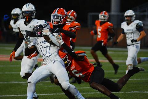 Keith Curry (11) and Jamir Rucker (6) bring down a St. Francis ball carrier in the win on Sept. 16.