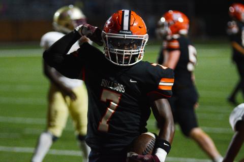 Nori Moore flexes after scoring his third rushing touchdown against Cross Creek. 