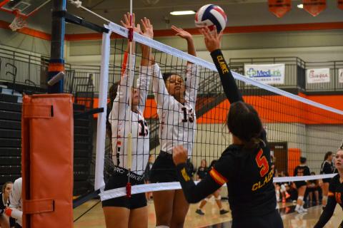 Ryleigh Jordan (left) and Alexis Walker (right) attempt a block against Cedar Shoals on Sept. 15.