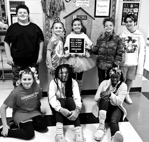 Hart County Middle School students wore “crazy socks and crazy hair” to show that from head to toe they are drugs and bully free. Pictured from left to right are, bottom row, Kimberly Lowney, Jo’niya Glaze, Brandi Harris, back row, Hayden Gunnels, Jacey Barnes, Aubrey Layman, Lance Shaffer, and Kaden Jacobson. 