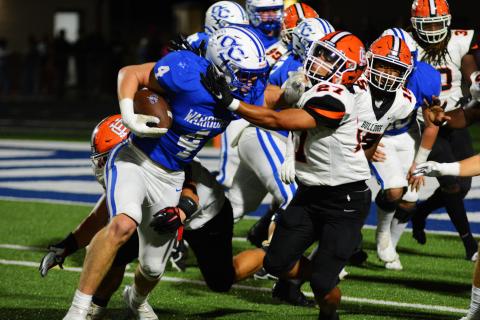Na’tayvious Martin wrestles down Oconee County’s star player, Whit Weeks, on a goal line play on Oct. 7. 
