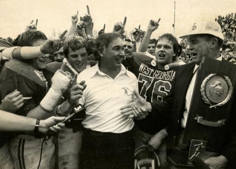 Bobby Pate receives the national championship trophy with his players in 1982.
