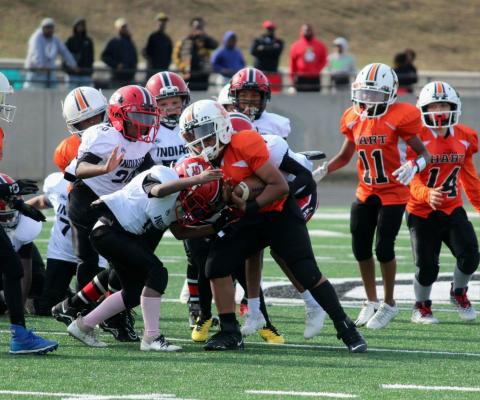 A 9U Hart County Bulldogs running back fights for extra yards in the NGYFA Championship win against Stephen County.
